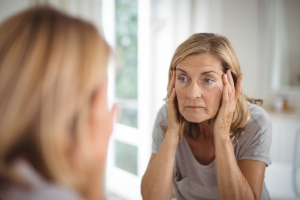 A woman looking at herself in the mirror